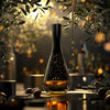 Elegant olive oil bottle under olive branches with golden lighting and tasting elements on a reflective table