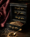 Mediterra Zaatar Edition No.8 blend of wild thyme, sesame seeds, and sumac displayed in an antique drawer with golden spoon on dark background