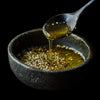 Authentic Levantine za’atar blend in a dark bowl, drizzled with olive oil, symbolizing Mediterranean culinary tradition