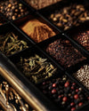 Luxury spice drawer filled with saffron, cardamom, peppercorns, and exotic herbs on a dark background featuring mediterra co official website herb blend product.
